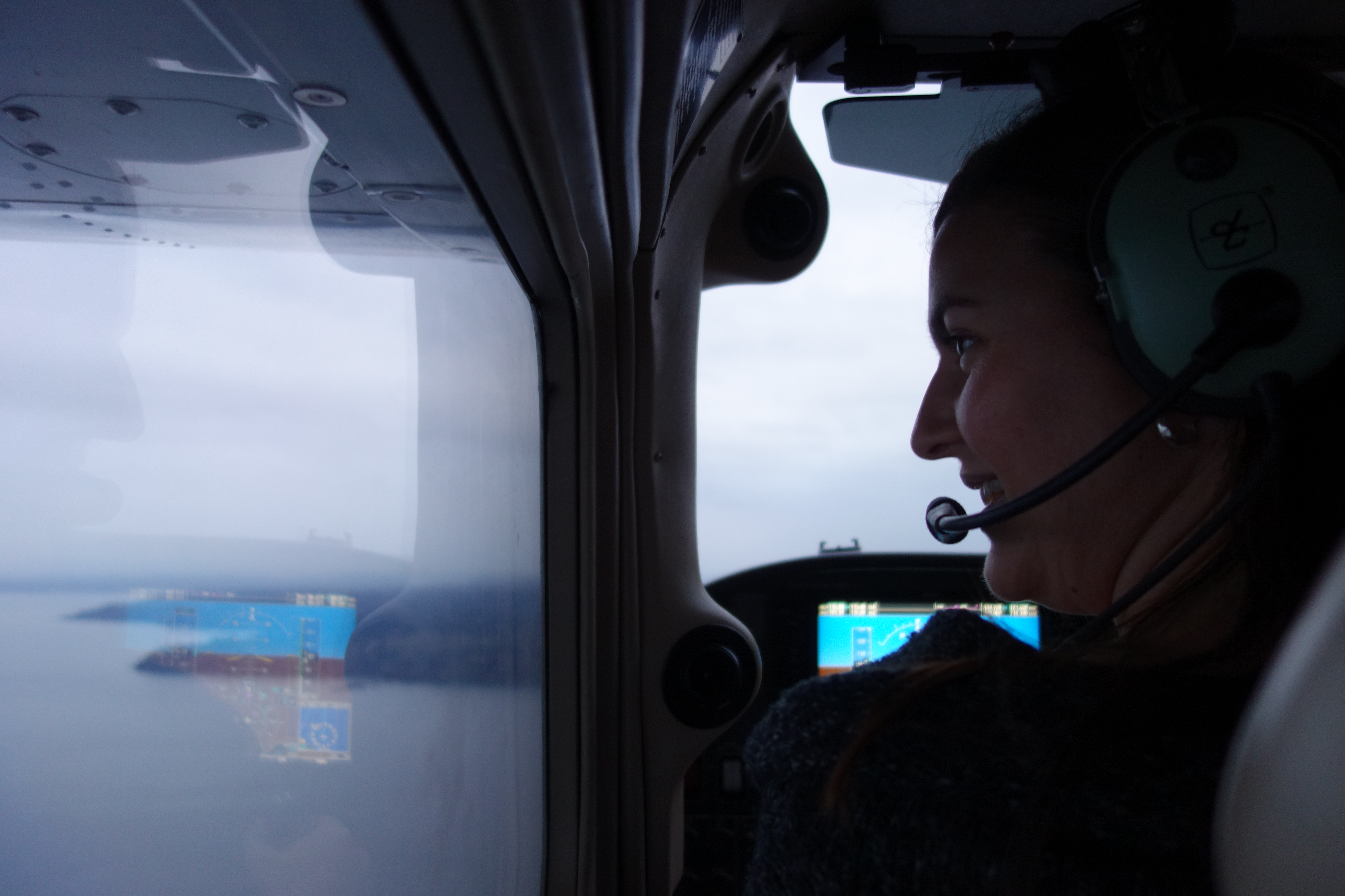 Suz flying a plane over water